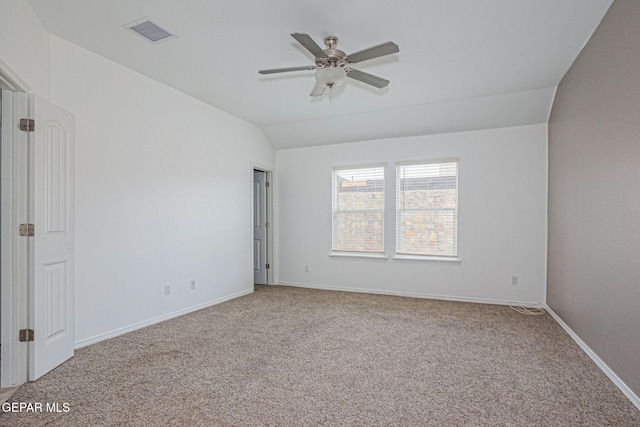 empty room with ceiling fan, light colored carpet, and lofted ceiling