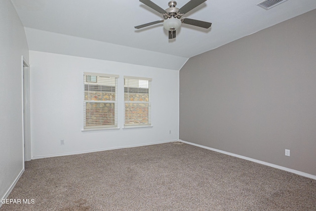 empty room featuring vaulted ceiling, ceiling fan, and carpet