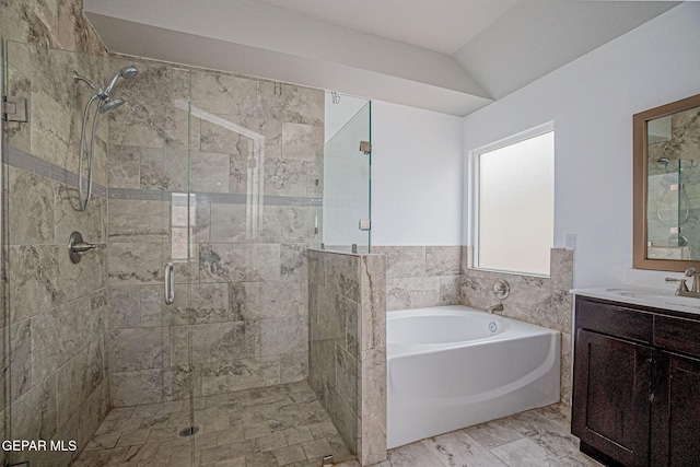 bathroom featuring vanity, separate shower and tub, and vaulted ceiling