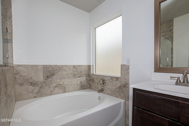 bathroom featuring a tub to relax in and vanity