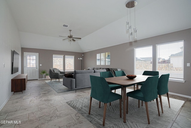 dining area featuring ceiling fan and lofted ceiling