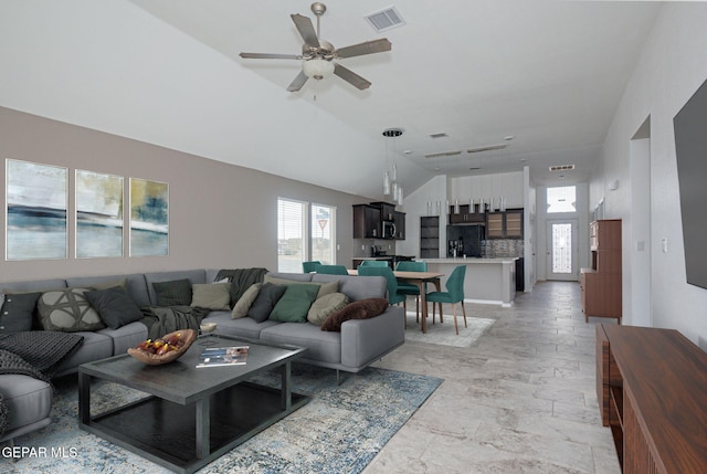 living room with vaulted ceiling and ceiling fan