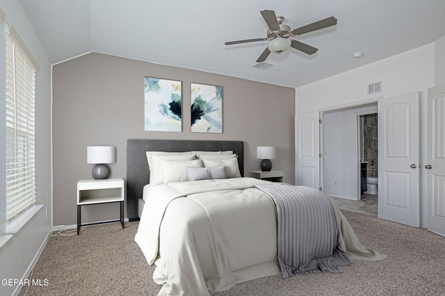 bedroom with vaulted ceiling, light colored carpet, and ceiling fan