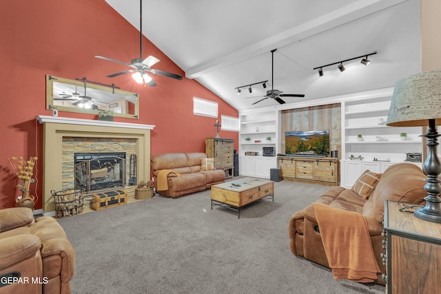 living room featuring high vaulted ceiling, a fireplace, track lighting, light carpet, and built in shelves