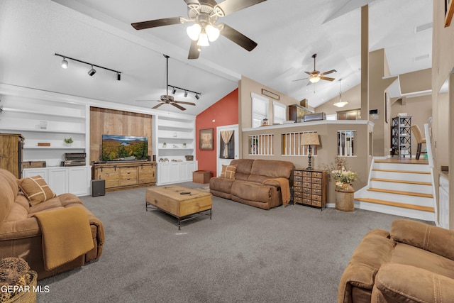 carpeted living room with track lighting, lofted ceiling, and built in features