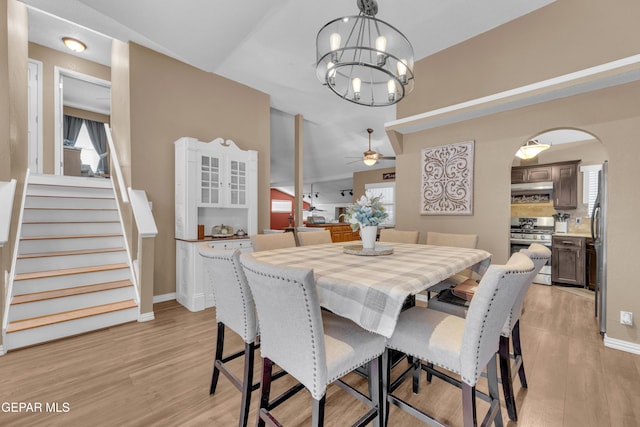 dining area featuring ceiling fan with notable chandelier and light hardwood / wood-style floors