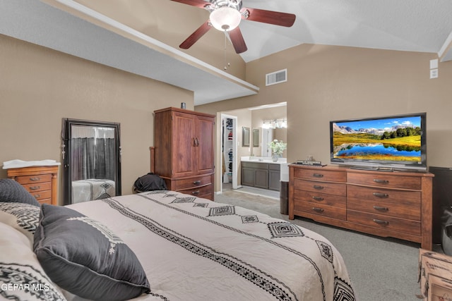 carpeted bedroom with lofted ceiling, ensuite bath, and ceiling fan