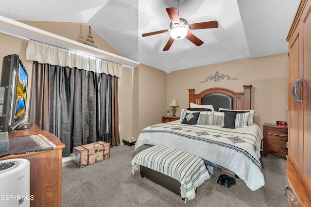 bedroom featuring ceiling fan, lofted ceiling, carpet, and a textured ceiling