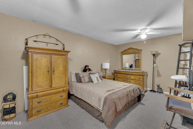 carpeted bedroom with ceiling fan and a textured ceiling