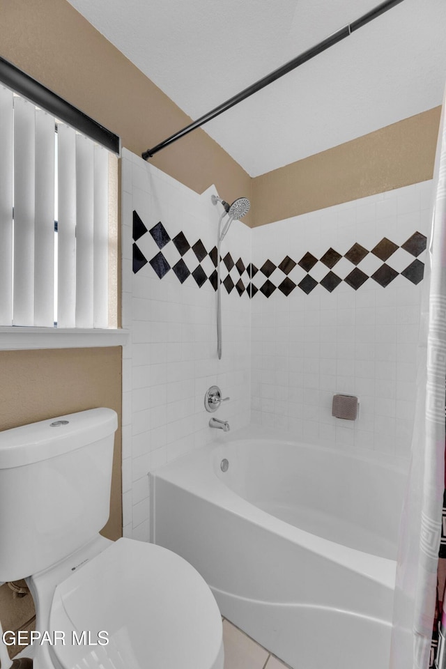 bathroom featuring shower / tub combo and toilet