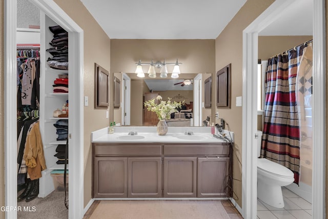 bathroom featuring walk in shower, vanity, and toilet