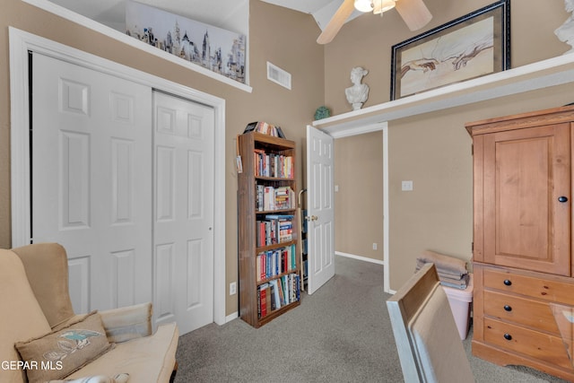 living area featuring carpet and ceiling fan