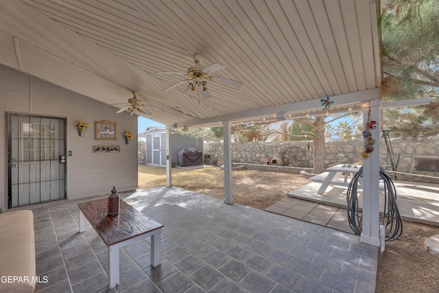 view of patio / terrace with a shed, area for grilling, and ceiling fan