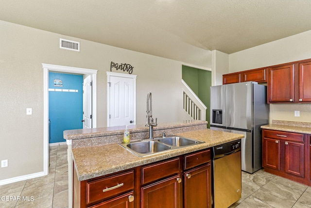 kitchen featuring stainless steel appliances, an island with sink, sink, and light tile patterned floors