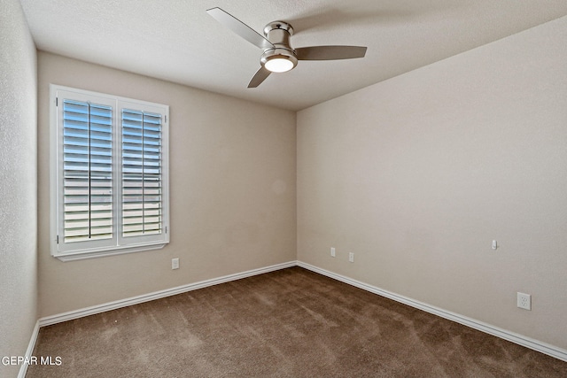 unfurnished room featuring a textured ceiling, ceiling fan, and dark colored carpet