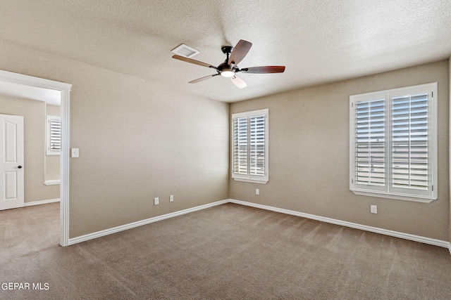 carpeted empty room with a textured ceiling and ceiling fan