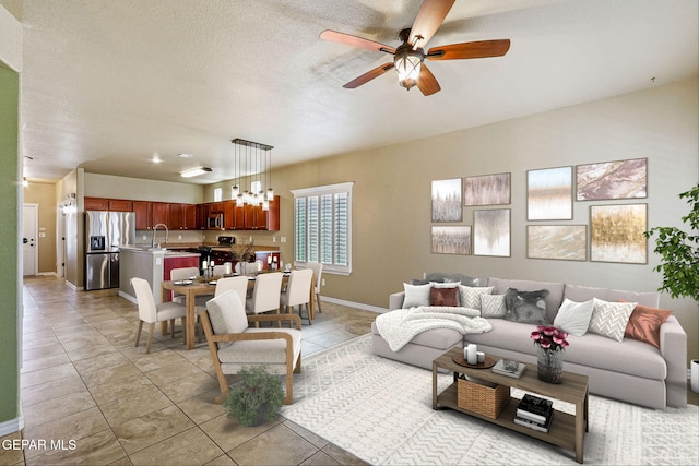 tiled living room featuring a textured ceiling and ceiling fan