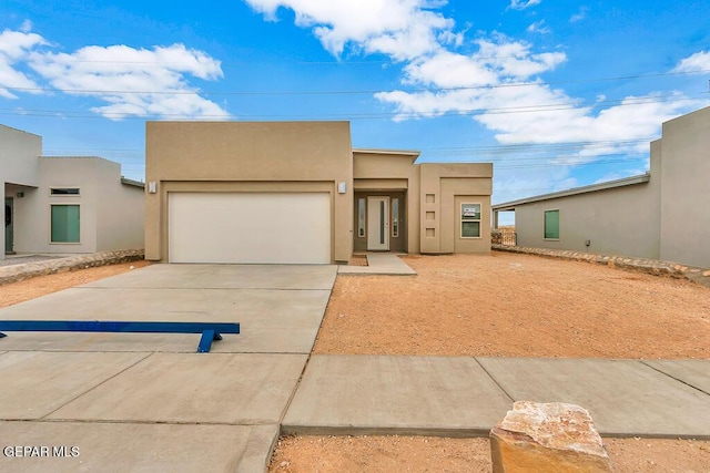 pueblo-style home with a garage