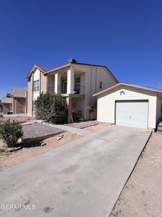 view of front of home featuring a garage and a balcony