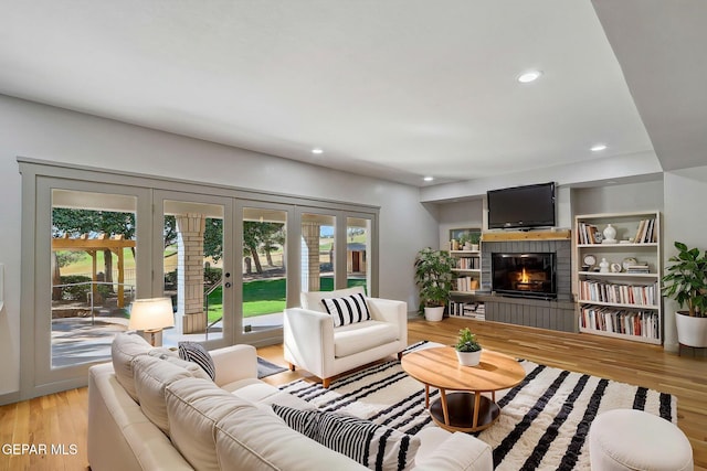 909 Singing Hills Dr, El Paso, TX 79912 - living area with french doors, light wood-style floors, recessed lighting, and a glass covered fireplace