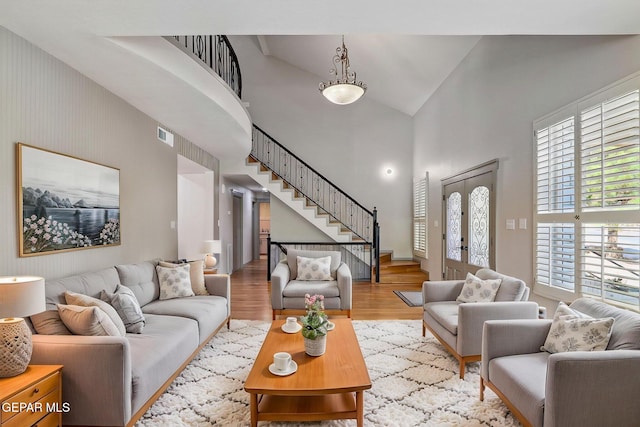 909 Singing Hills Dr, El Paso, TX 79912 - living area featuring a high ceiling, stairs, and wood finished floors