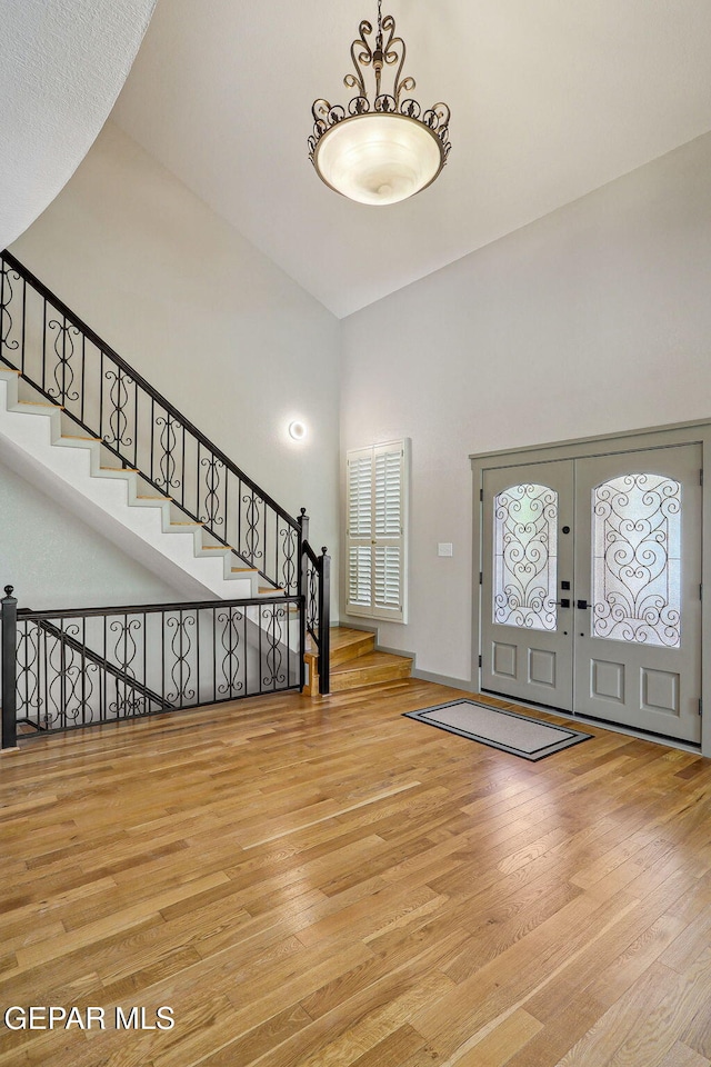 909 Singing Hills Dr, El Paso, TX 79912 - entrance foyer with a towering ceiling, wood finished floors, stairs, and french doors