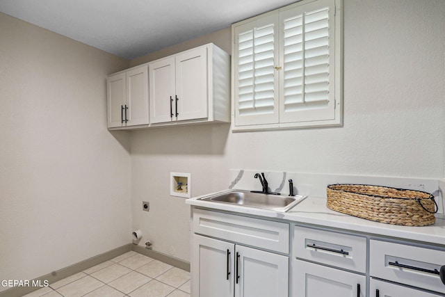 909 Singing Hills Dr, El Paso, TX 79912 - clothes washing area with cabinet space, electric dryer hookup, washer hookup, baseboards, and light tile patterned floors