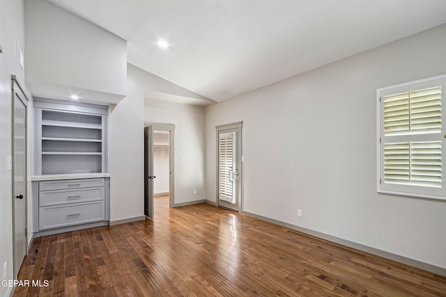 909 Singing Hills Dr, El Paso, TX 79912 - unfurnished bedroom with dark wood finished floors, high vaulted ceiling, and baseboards