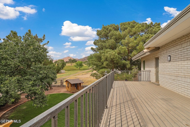 909 Singing Hills Dr, El Paso, TX 79912 - deck with an outdoor structure, a mountain view, a yard, and a storage shed
