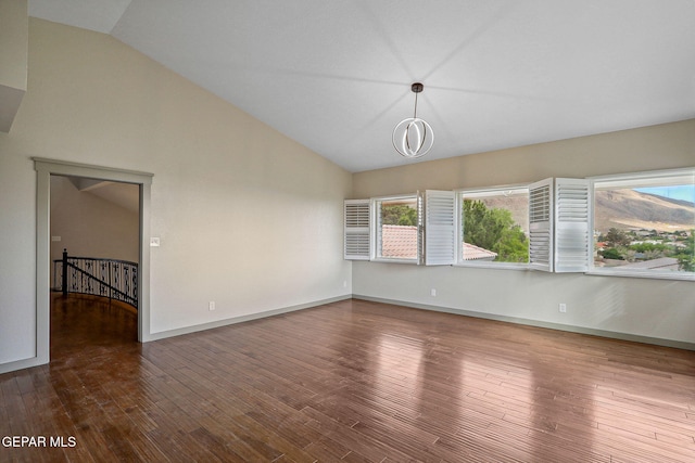 909 Singing Hills Dr, El Paso, TX 79912 - spare room with vaulted ceiling, wood finished floors, and baseboards