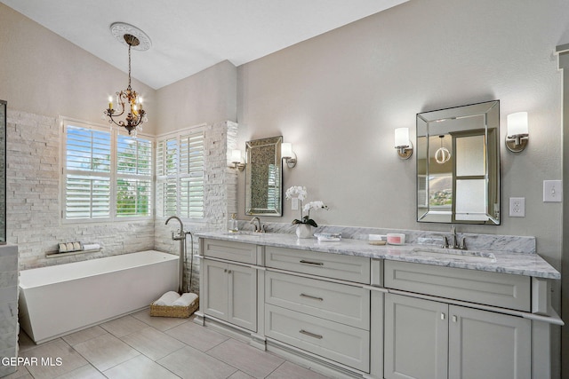 909 Singing Hills Dr, El Paso, TX 79912 - bathroom with a chandelier, double vanity, a freestanding tub, tile patterned flooring, and lofted ceiling