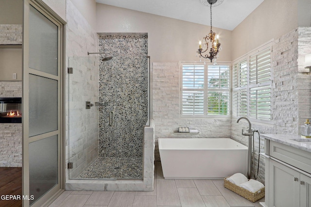 909 Singing Hills Dr, El Paso, TX 79912 - full bathroom featuring a stall shower, a freestanding tub, a chandelier, and vanity