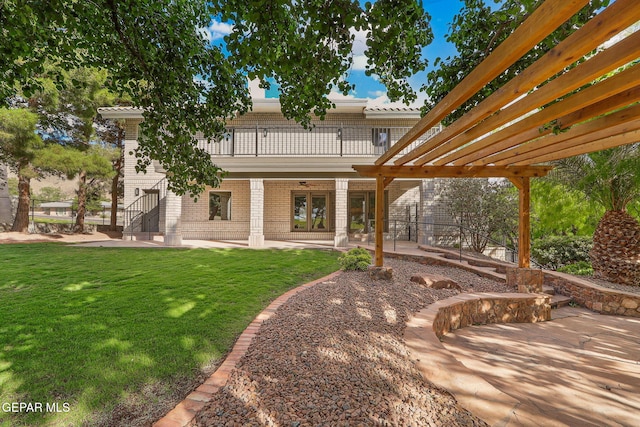 909 Singing Hills Dr, El Paso, TX 79912 - rear view of property with a patio, a lawn, a balcony, and brick siding