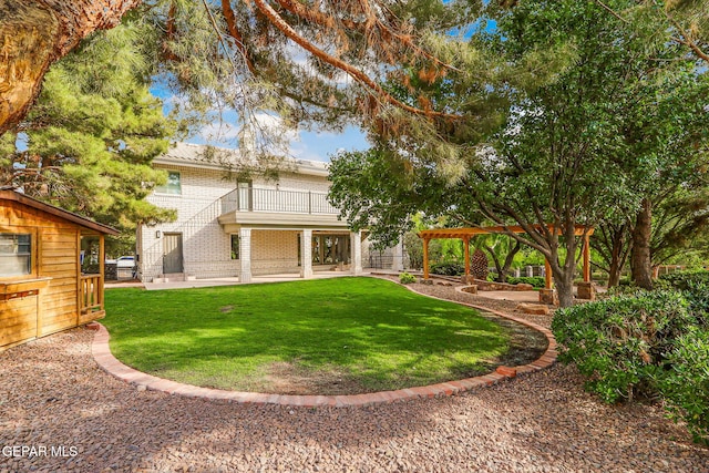 909 Singing Hills Dr, El Paso, TX 79912 - rear view of house featuring a balcony, brick siding, a yard, and a patio area
