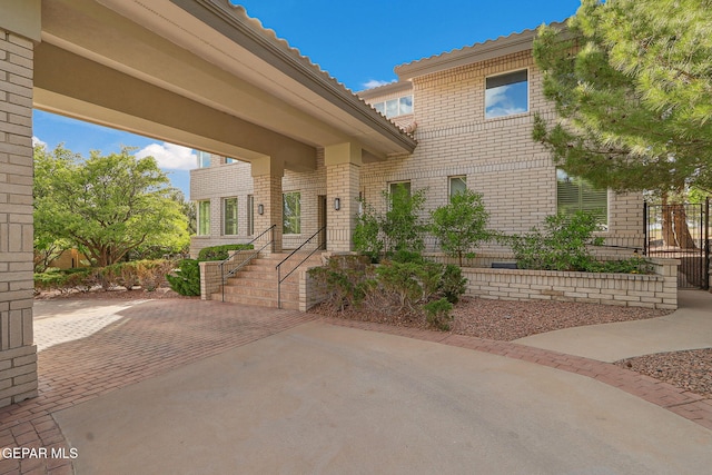 909 Singing Hills Dr, El Paso, TX 79912 - entrance to property with brick siding, a patio, and fence
