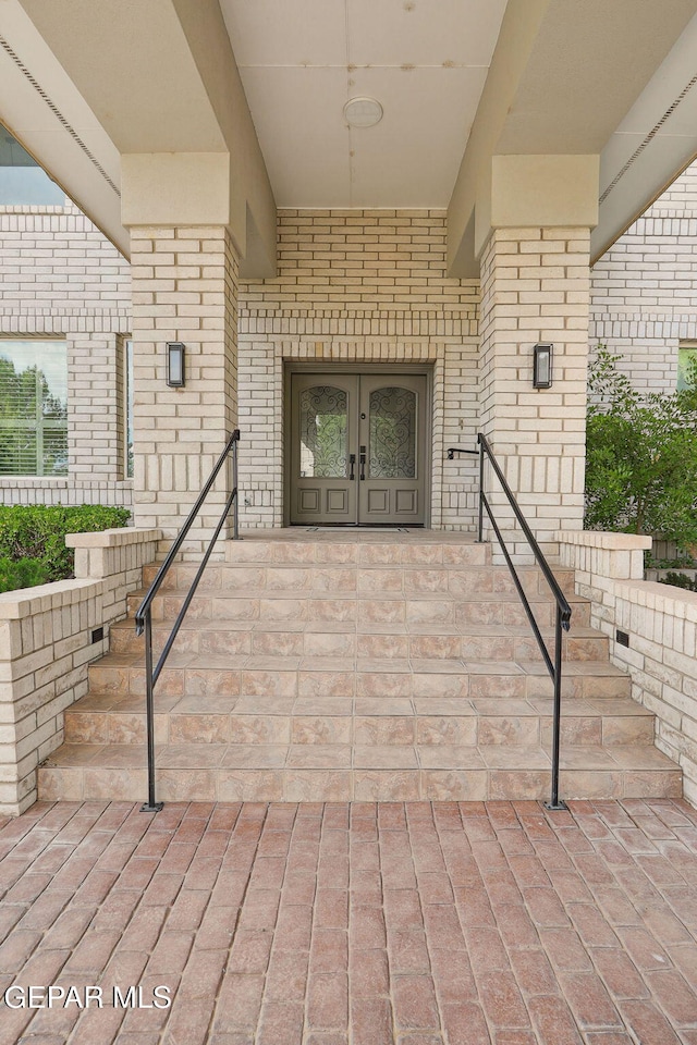 909 Singing Hills Dr, El Paso, TX 79912 - view of exterior entry featuring french doors and brick siding