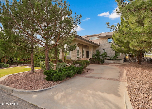 909 Singing Hills Dr, El Paso, TX 79912 - view of front of home with a tiled roof and brick siding