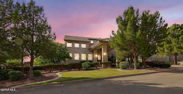 909 Singing Hills Dr, El Paso, TX 79912 - view of front of house with a front yard, a tiled roof, and brick siding