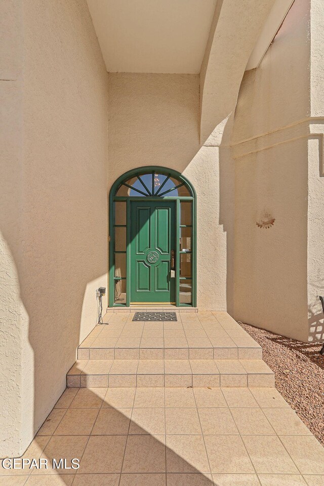 doorway to property with stucco siding