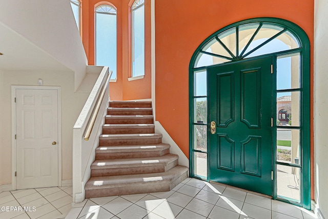 entryway featuring stairway and light tile patterned floors
