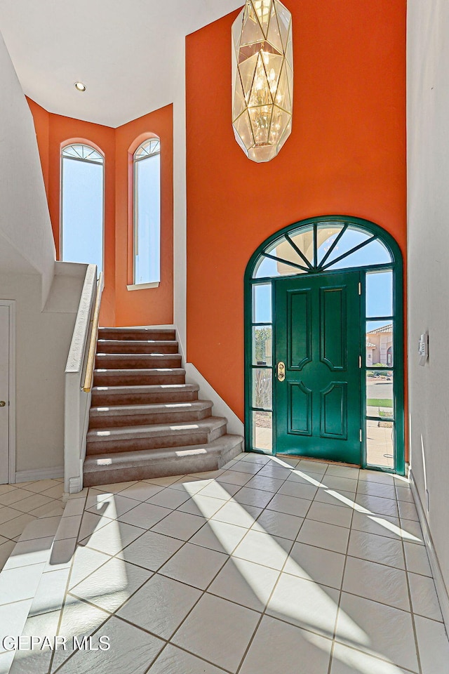 tiled entryway with a wealth of natural light and stairway