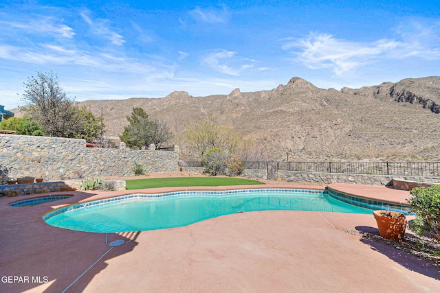 view of swimming pool with an in ground hot tub, a patio area, a fenced in pool, a fenced backyard, and a mountain view