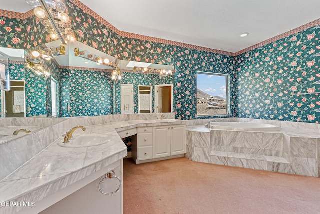 bathroom with wallpapered walls, vanity, and a garden tub
