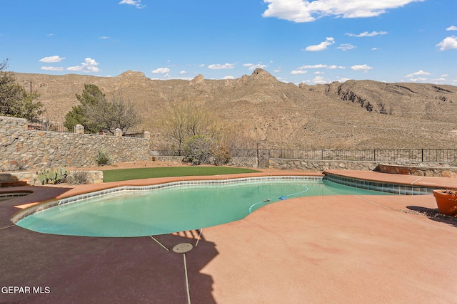 view of pool featuring a fenced backyard, a fenced in pool, a mountain view, and a patio