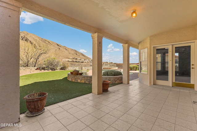 view of patio / terrace featuring a mountain view and fence private yard
