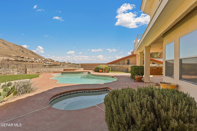 view of swimming pool featuring fence, an in ground hot tub, a patio area, and a fenced in pool
