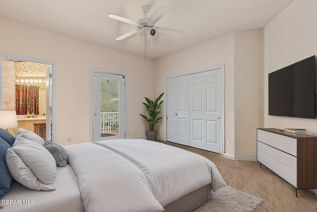 bedroom featuring baseboards, ensuite bath, access to exterior, ceiling fan, and a closet