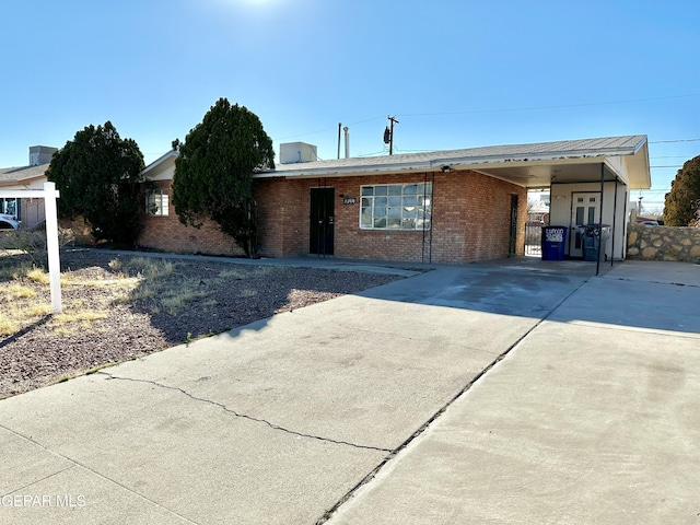 ranch-style home featuring a carport