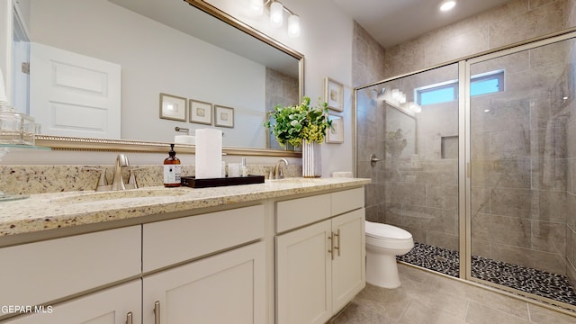 bathroom featuring vanity, toilet, an enclosed shower, and tile patterned flooring