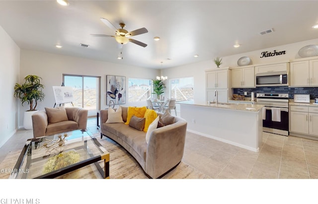 living room featuring sink and ceiling fan